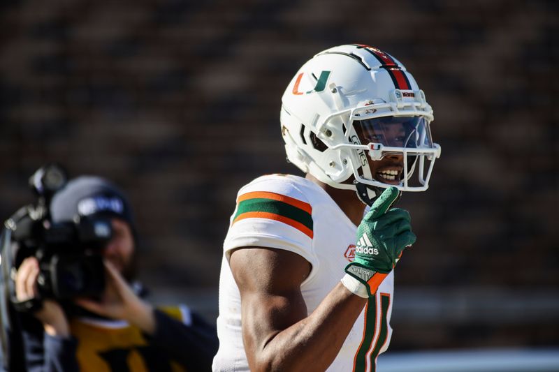 Nov 27, 2021; Durham, North Carolina, USA;  Miami Hurricanes wide receiver Charleston Rambo (11) scores a touchdown during the first half of the game against the Miami Hurricanes at Wallace Wade Stadium. at Wallace Wade Stadium. Mandatory Credit: Jaylynn Nash-USA TODAY Sports