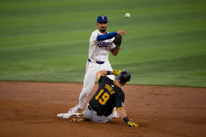 Aug 21, 2024; Arlington, Texas, USA; Texas Rangers second baseman Marcus Semien (2) puts out Pittsburgh Pirates third baseman Jared Triolo (19) as he turns a double play during the second inning at Globe Life Field. Mandatory Credit: Jerome Miron-USA TODAY Sports