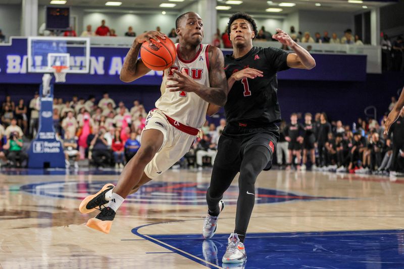 Feb 22, 2024; Boca Raton, Florida, USA; Florida Atlantic Owls guard Johnell Davis (1) drives to the basket against Southern Methodist Mustangs guard Zhuric Phelps (1) during the second half at Eleanor R. Baldwin Arena. Mandatory Credit: Sam Navarro-USA TODAY Sports