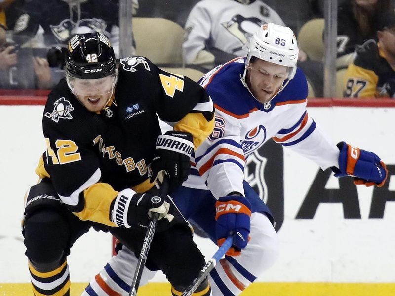 Feb 23, 2023; Pittsburgh, Pennsylvania, USA; Pittsburgh Penguins right wing Kasperi Kapanen (42) and Edmonton Oilers defenseman Philip Broberg (86) battle for the puck during the third period at PPG Paints Arena. Edmonton won 7-2. Mandatory Credit: Charles LeClaire-USA TODAY Sports