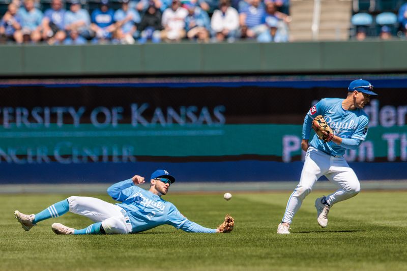 Apr 21, 2024; Kansas City, Missouri, USA; Kansas City Royals outfielder Garrett Hampson (2) and Kansas City Royals second base Adam Frazier (26) collide in the outfield going after a fly ball during the second inning against the Baltimore Orioles at Kauffman Stadium. Mandatory Credit: William Purnell-USA TODAY Sports