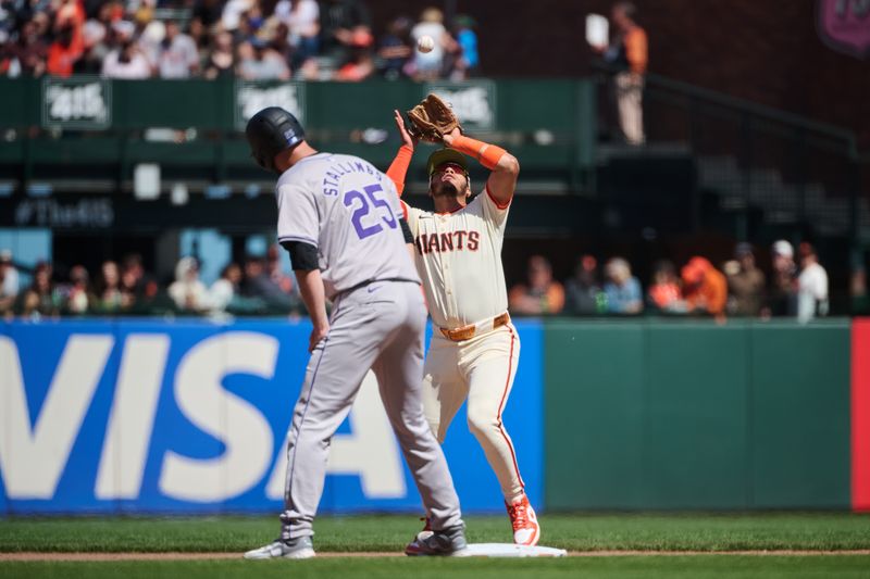 May 19, 2024; San Francisco, California, USA; San Francisco Giants infielder Thairo Estrada (39) catches a fly ball next to Colorado Rockies catcher Jacob Stallings (25) during the eighth inning at Oracle Park. Mandatory Credit: Robert Edwards-USA TODAY Sports