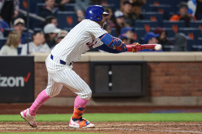 May 12, 2024; New York City, New York, USA; New York Mets second baseman Jeff McNeil (1) bunts for a base hit during the ninth inning against the Atlanta Braves at Citi Field. Mandatory Credit: Vincent Carchietta-USA TODAY Sports