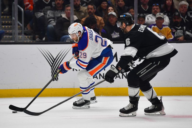 Apr 29, 2025; Los Angeles, California, USA; Edmonton Oilers center Leon Draisaitl (29) moves the puck against Los Angeles Kings defenseman Joel Edmundson (6) during the first period in game five of the first round of the 2025 Stanley Cup Playoffs at Crypto.com Arena. Mandatory Credit: Gary A. Vasquez-Imagn Images