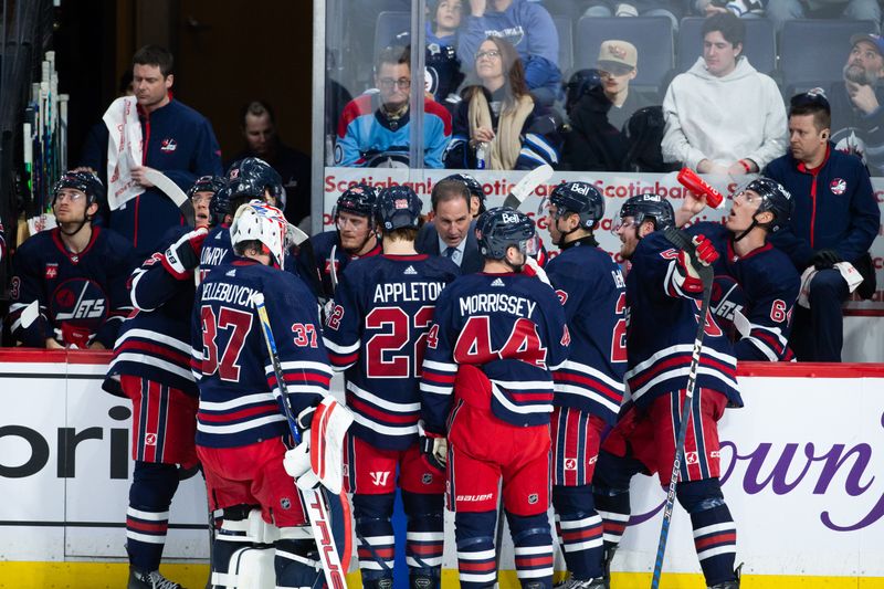 Feb 10, 2024; Winnipeg, Manitoba, CAN;  Winnipeg Jets associate  coach Scott Ariel discusses strategy against the Pittsburgh Penguins during the third period at Canada Life Centre. Mandatory Credit: Terrence Lee-USA TODAY Sports