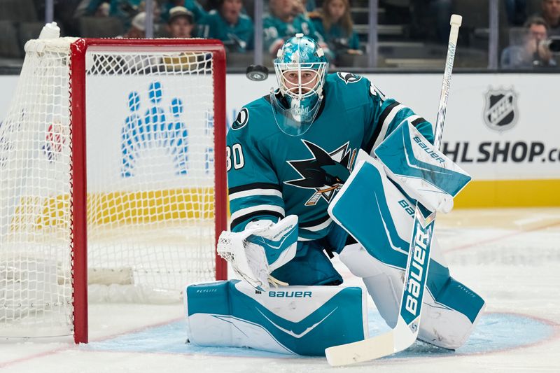 Sep 26, 2025; San Jose, California, USA; San Jose Sharks goaltender Yaroslav Askarov (30) watches a puck in the air after making a save against the Vegas Golden Knights during the first period at SAP Center at San Jose. Mandatory Credit: Robert Edwards-Imagn Images