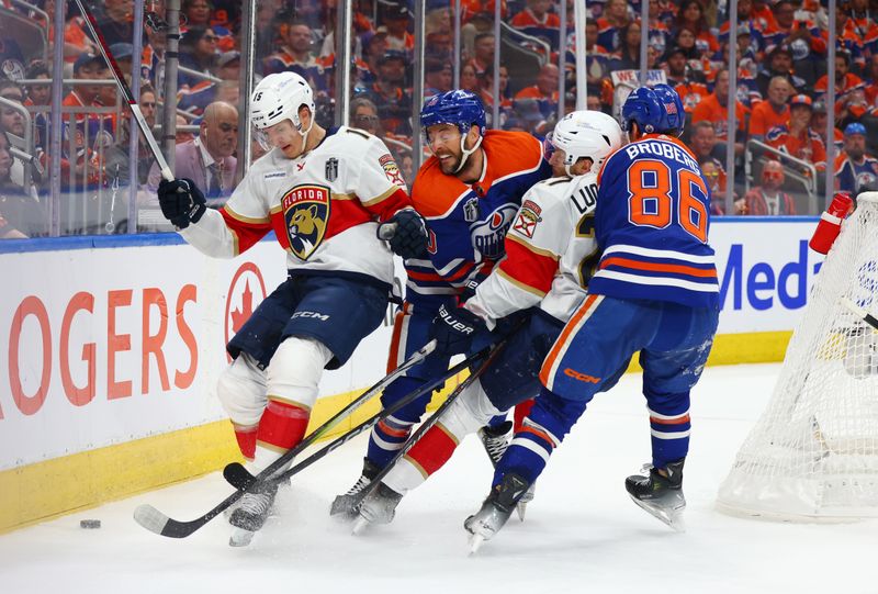 June 21, 2024; Edmonton, Alberta, CAN; Florida Panthers center Anton Lundell (15) battles along the boards with Edmonton Oilers center Derek Ryan (10) for the puck in the first period in game six of the 2024 Stanley Cup Final at Rogers Place. Mandatory Credit: Sergei Belski-USA TODAY Sports