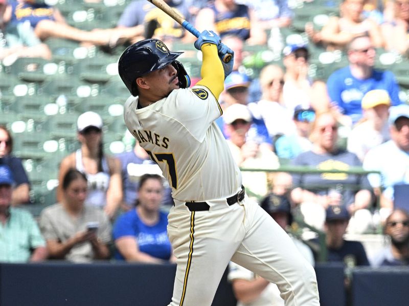 Jun 12, 2024; Milwaukee, Wisconsin, USA; Milwaukee Brewers shortstop Willy Adames (27) hits a home run against the Toronto Blue Jays in the sixth inning at American Family Field. Mandatory Credit: Michael McLoone-USA TODAY Sports