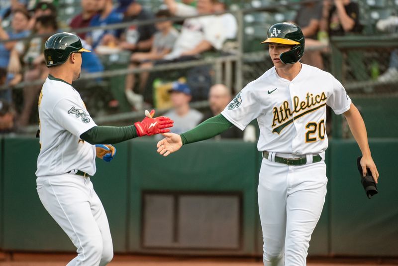 Aug 22, 2023; Oakland, California, USA; Oakland Athletics second baseman Zack Gelof (20) celebrates with shortstop Aledmys Diaz (12) after scoring during the first inning against the Kansas City Royals at Oakland-Alameda County Coliseum. Mandatory Credit: Ed Szczepanski-USA TODAY Sports