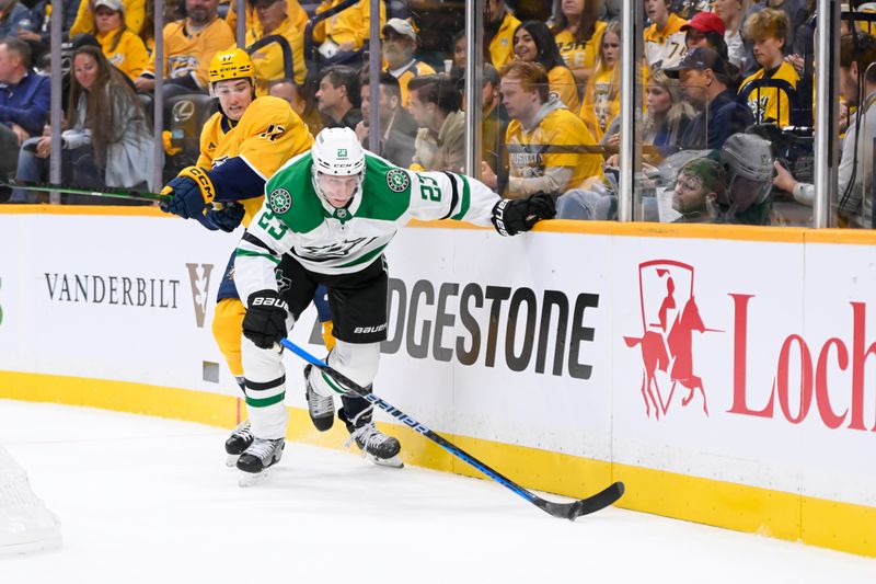 Oct 10, 2024; Nashville, Tennessee, USA; Dallas Stars defenseman Esa Lindell (23) steals the puck from Nashville Predators center Mark Jankowski (17) during the first period at Bridgestone Arena. Mandatory Credit: Steve Roberts-Imagn Images