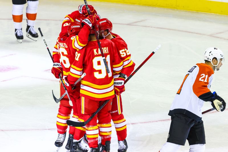 Oct 12, 2024; Calgary, Alberta, CAN; Calgary Flames defenseman MacKenzie Weegar (52) celebrates his goal with teammates against the Philadelphia Flyers during the first period at Scotiabank Saddledome. Mandatory Credit: Sergei Belski-Imagn Images