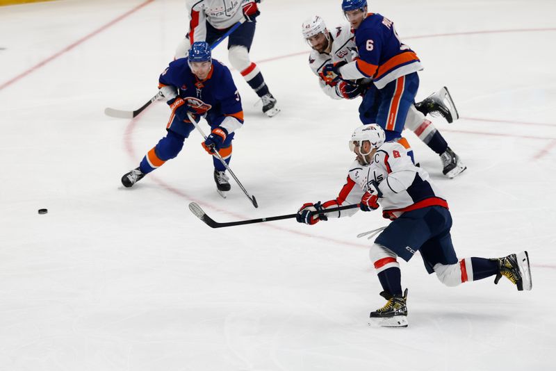 Apr 6, 2025; Elmont, New York, USA;  Washington Capitals forward Alex Ovechkin (8) shoots the puck during the third period against the New York Islanders at UBS Arena. Mandatory Credit: Geoff Burke-Imagn Images