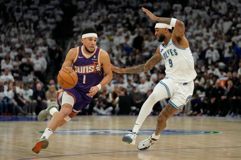 MINNEAPOLIS, MINNESOTA - APRIL 20: Devin Booker #1 of the Phoenix Suns dribbles the ball against Nickeil Alexander-Walker #9 of the Minnesota Timberwolves during the second half in game one of the Western Conference First Round Playoffs at Target Center on April 20, 2024 in Minneapolis, Minnesota. NOTE TO USER: User expressly acknowledges and agrees that, by downloading and or using this photograph, User is consenting to the terms and conditions of the Getty Images License Agreement. (Photo by Patrick McDermott/Getty Images)