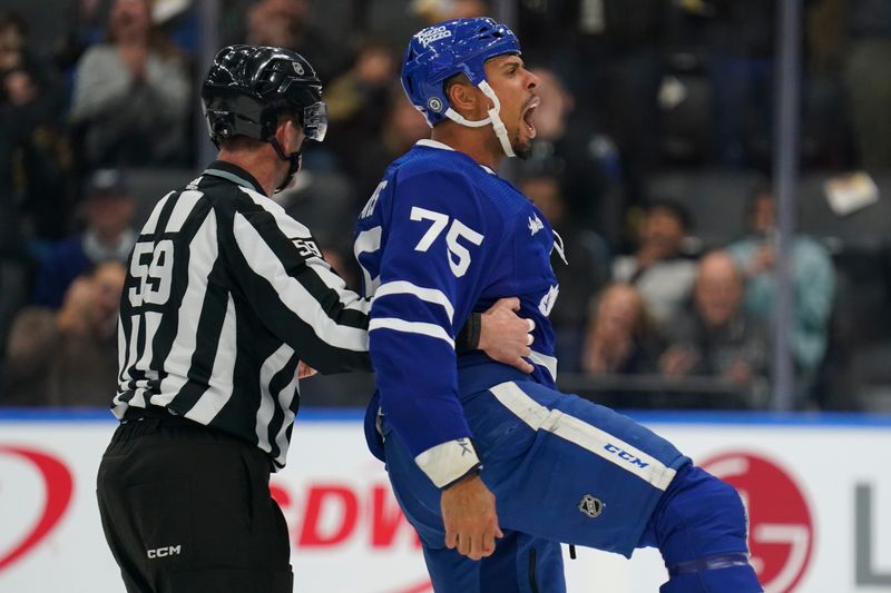 Feb 29, 2024; Toronto, Ontario, CAN; Toronto Maple Leafs forward Ryan Reaves (75) reacts after a fight with Arizona Coyotes forward Liam O'Brien (not pictured) as linesperson Steve Barton (59) guides him to the penalty box during the first period at Scotiabank Arena. Mandatory Credit: John E. Sokolowski-USA TODAY Sports