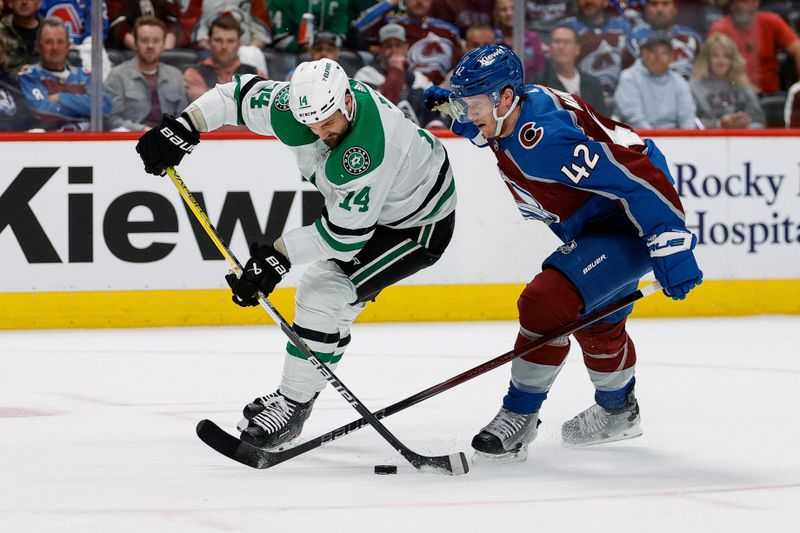 May 13, 2024; Denver, Colorado, USA; Dallas Stars left wing Jamie Benn (14) controls the puck ahead of Colorado Avalanche defenseman Josh Manson (42) in the first period in game four of the second round of the 2024 Stanley Cup Playoffs at Ball Arena. Mandatory Credit: Isaiah J. Downing-USA TODAY Sports