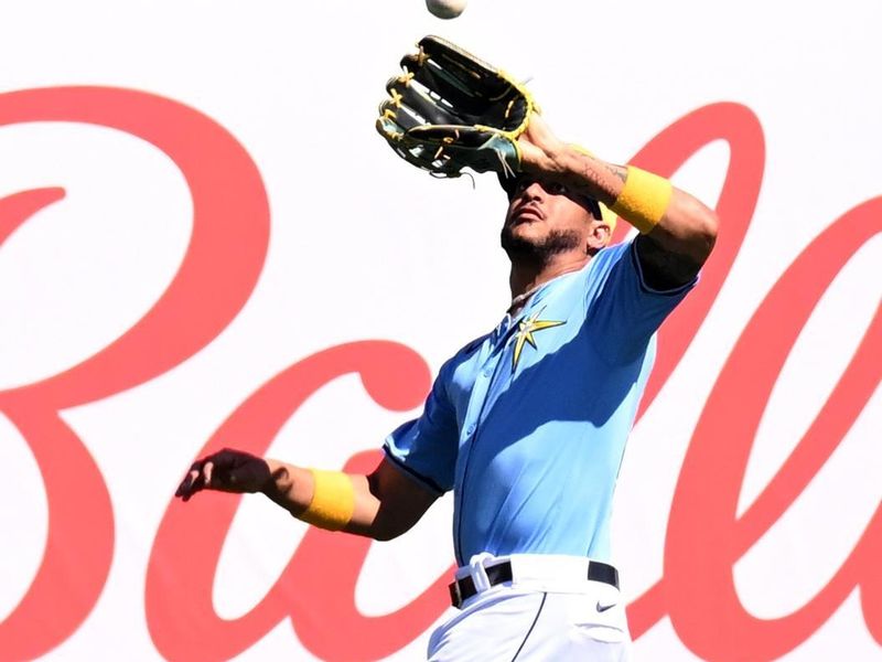 Feb 24, 2024; Port Charlotte, Florida, USA; Tampa Bay Rays center fielder Jose Siri (22) catches a fly ball in the first inning of a spring training game against the Atlanta Braves at Charlotte Sports Park. Mandatory Credit: Jonathan Dyer-USA TODAY Sports