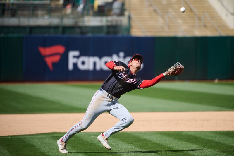 Apr 14, 2024; Oakland, California, USA; Washington Nationals third baseman Trey Lipscomb (38) extends to catch a fly ball in the infield against the Oakland Athletics during the eighth inning at Oakland-Alameda County Coliseum. Mandatory Credit: Robert Edwards-USA TODAY Sports