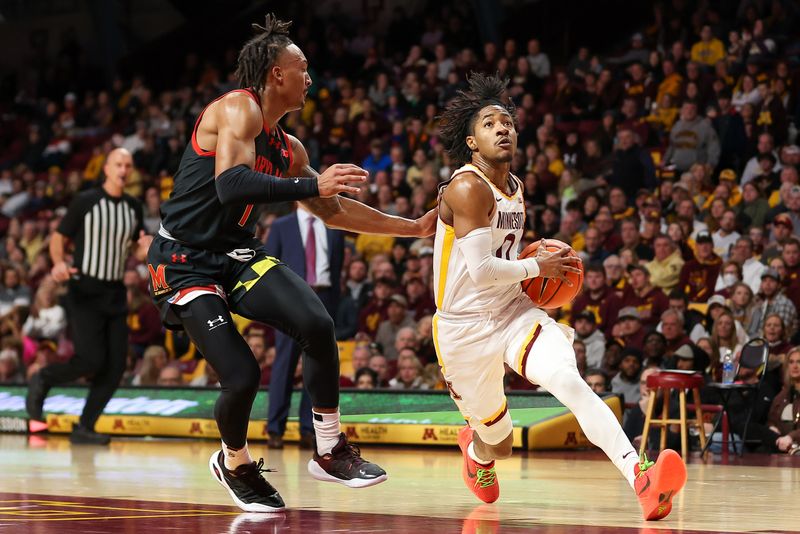 Jan 7, 2024; Minneapolis, Minnesota, USA; Minnesota Golden Gophers guard Elijah Hawkins (0) works towards the basket as Maryland Terrapins guard Jahmir Young (1) defends during the first half at Williams Arena. Mandatory Credit: Matt Krohn-USA TODAY Sports