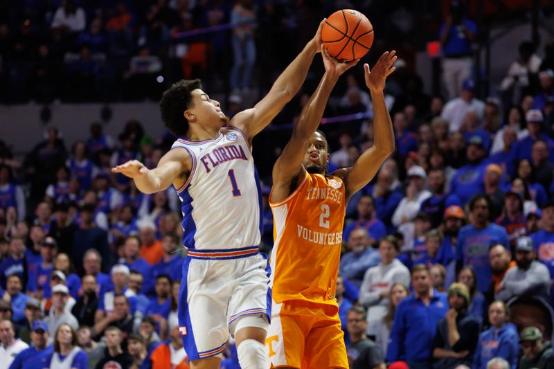 Jan 7, 2025; Gainesville, Florida, USA; Florida Gators guard Walter Clayton Jr. (1) blocks a three point basket from Tennessee Volunteers guard Chaz Lanier (2) during the first half at Exactech Arena at the Stephen C. O'Connell Center. Mandatory Credit: Matt Pendleton-Imagn Images