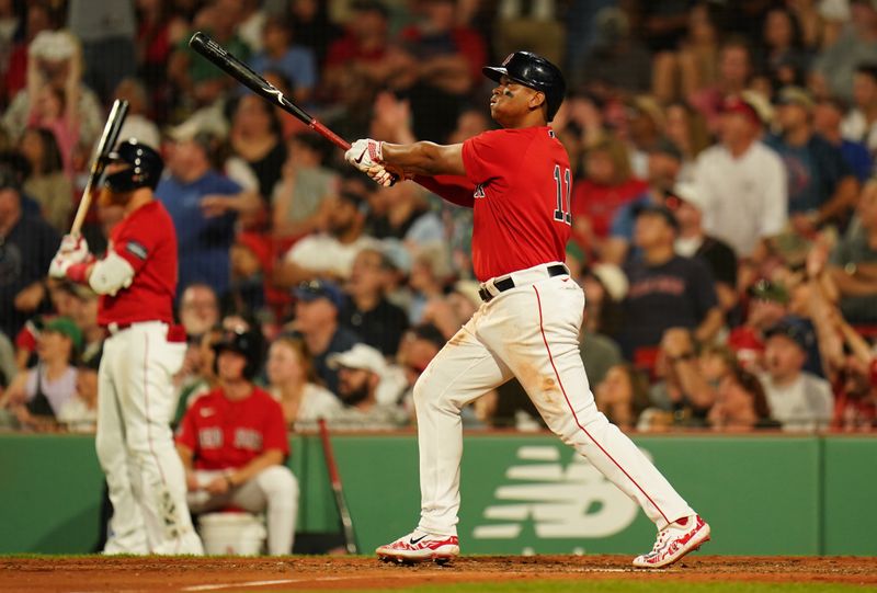 Jun 1, 2023; Boston, Massachusetts, USA; Boston Red Sox third baseman Rafael Devers (11) hits a double to center field to drive in a run against the Cincinnati Reds in the eighth inning at Fenway Park. Mandatory Credit: David Butler II-USA TODAY Sports