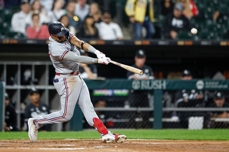 Sep 15, 2023; Chicago, Illinois, USA; Minnesota Twins third baseman Royce Lewis (23) hits a grand slam against the Chicago White Sox during the second inning at Guaranteed Rate Field. Mandatory Credit: Kamil Krzaczynski-USA TODAY Sports