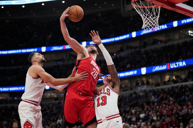 CHICAGO, ILLINOIS - NOVEMBER 17: Alperen Sengun #28 of the Houston Rockets shoots the ball against Torrey Craig #13 of the Chicago Bulls during the third quarter at the United Center on November 17, 2024 in Chicago, Illinois. NOTE TO USER: User expressly acknowledges and agrees that, by downloading and or using this photograph, User is consenting to the terms and conditions of the Getty Images License Agreement. (Photo by Patrick McDermott/Getty Images)