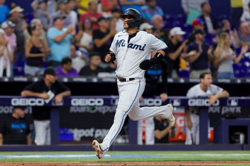 Jul 30, 2023; Miami, Florida, USA; Miami Marlins first baseman Yuli Gurriel (10) scores after an rbi double by catcher Nick Fortes (not pictured) during the fifth inning at loanDepot Park. Mandatory Credit: Sam Navarro-USA TODAY Sports