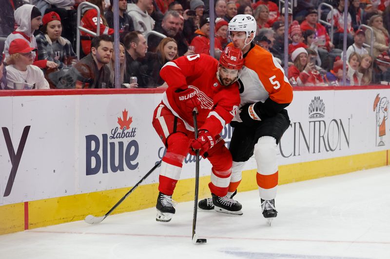 Dec 22, 2023; Detroit, Michigan, USA;  Detroit Red Wings center Joe Veleno (90) and Philadelphia Flyers defenseman Egor Zamula (5) battle for the puck in the second period at Little Caesars Arena. Mandatory Credit: Rick Osentoski-USA TODAY Sports