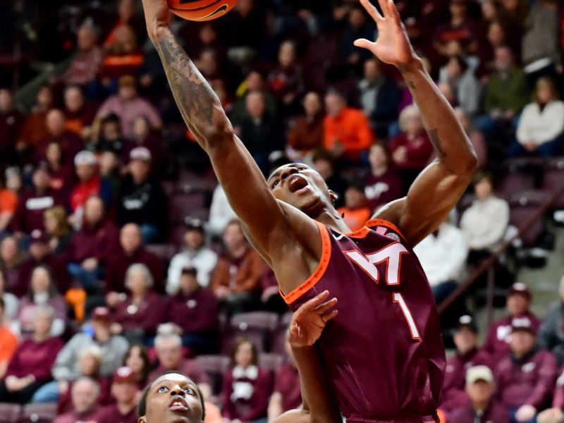 Feb 15, 2025; Blacksburg, Virginia, USA; Virginia Tech Hokies forward Tobi Lawal (1) goes up for a shot as Virginia Cavaliers guard Dai Dai Ames (7) watches during the first half at Cassell Coliseum. Mandatory Credit: Brian Bishop-Imagn Images