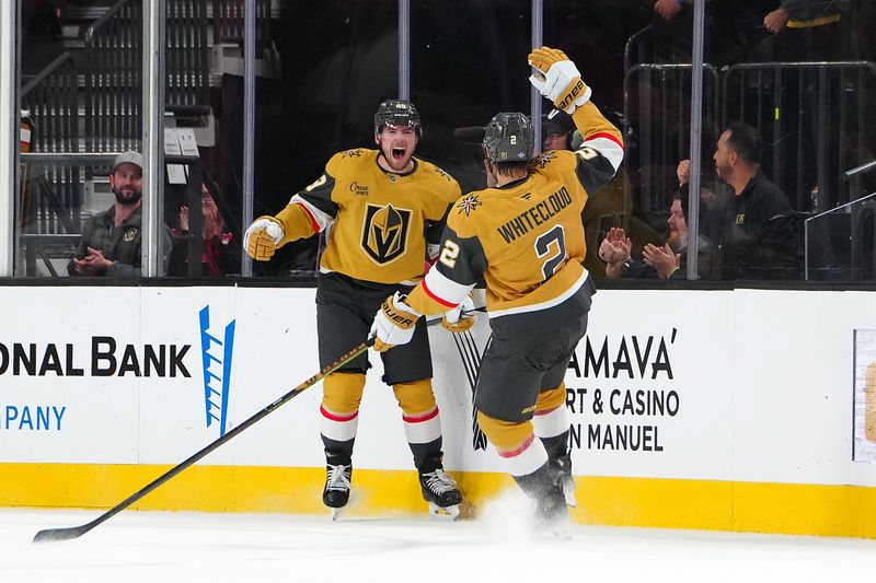 Oct 11, 2024; Las Vegas, Nevada, USA; Vegas Golden Knights center Ivan Barbashev (49) celebrates with Vegas Golden Knights defenseman Zach Whitecloud (2) after scoring a goal against the St. Louis Blues during the first period at T-Mobile Arena. Mandatory Credit: Stephen R. Sylvanie-Imagn Images