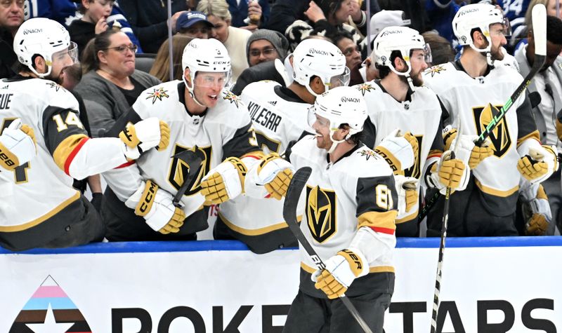 Feb 27, 2024; Toronto, Ontario, CAN;   Vegas Golden Knights forward Jonathan Marchessault (81) celebrates with team mates at the bench after scoring against the Toronto Maple Leafs in the third period at Scotiabank Arena. Mandatory Credit: Dan Hamilton-USA TODAY Sports