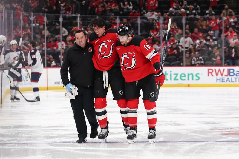 Dec 1, 2025; Newark, New Jersey, USA; New Jersey Devils defenseman Brenden Dillon (5) is helped off the ice after a fight during the second period of their game against the Columbus Blue Jackets at Prudential Center. Mandatory Credit: Ed Mulholland-Imagn Images