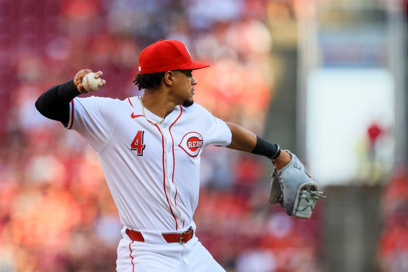 Jun 24, 2024; Cincinnati, Ohio, USA; Cincinnati Reds third baseman Santiago Espinal (4) throws to first to get Pittsburgh Pirates designated hitter Andrew McCutchen (not pictured) out in the first inning at Great American Ball Park. Mandatory Credit: Katie Stratman-USA TODAY Sports