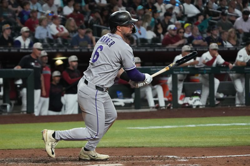 May 18, 2025; Phoenix, Arizona, USA; Colorado Rockies second base Kyle Farmer (6) hits a single against the Arizona Diamondbacks in the ninth inning at Chase Field. Mandatory Credit: Rick Scuteri-Imagn Images