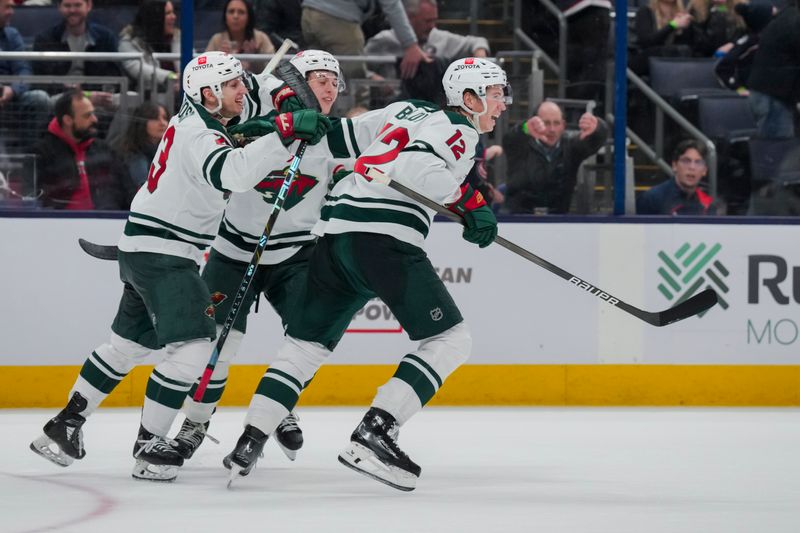 Jan 6, 2024; Columbus, Ohio, USA;  Minnesota Wild center Marco Rossi (23) celebrates with teammate defenseman Brock Faber (7) and left wing Matt Boldy (12) after scoring the game-winning goal against the Columbus Blue Jackets in the overtime period at Nationwide Arena. Mandatory Credit: Aaron Doster-USA TODAY Sports