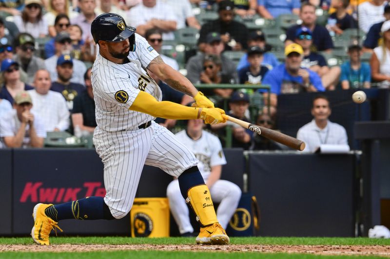 Jun 2, 2024; Milwaukee, Wisconsin, USA;  Milwaukee Brewers designated hitter Gary Sanchez (99) hits a single to drive in two runs against the Chicago White Sox in the eighth inning at American Family Field. Mandatory Credit: Benny Sieu-USA TODAY Sports