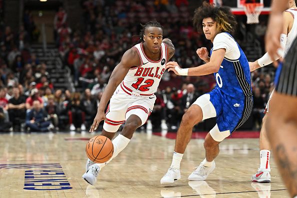 CHICAGO, ILLINOIS - NOVEMBER 15:  Ayo Dosunmu #12 of the Chicago Bulls controls the ball against the Orlando Magic on November 15, 2023 at United Center in Chicago, Illinois.   NOTE TO USER: User expressly acknowledges and agrees that, by downloading and or using this photograph, User is consenting to the terms and conditions of the Getty Images License Agreement.  (Photo by Jamie Sabau/Getty Images)