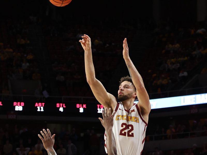 Feb 27, 2023; Ames, Iowa, USA; Iowa State Cyclones guard Gabe Kalscheur (22) scores over West Virginia Mountaineers guard Joe Toussaint (5) during the second half at James H. Hilton Coliseum. Mandatory Credit: Reese Strickland-USA TODAY Sports