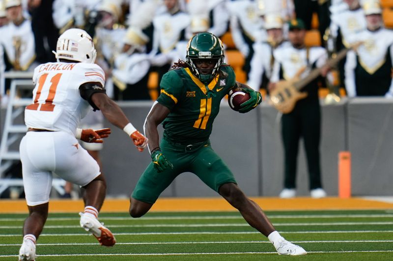 Sep 23, 2023; Waco, Texas, USA;  Baylor Bears wide receiver Ketron Jackson Jr. (11) makes a catch and is tackled by Texas Longhorns defensive back Jalen Catalon (11) during the first half at McLane Stadium. Mandatory Credit: Chris Jones-USA TODAY Sports