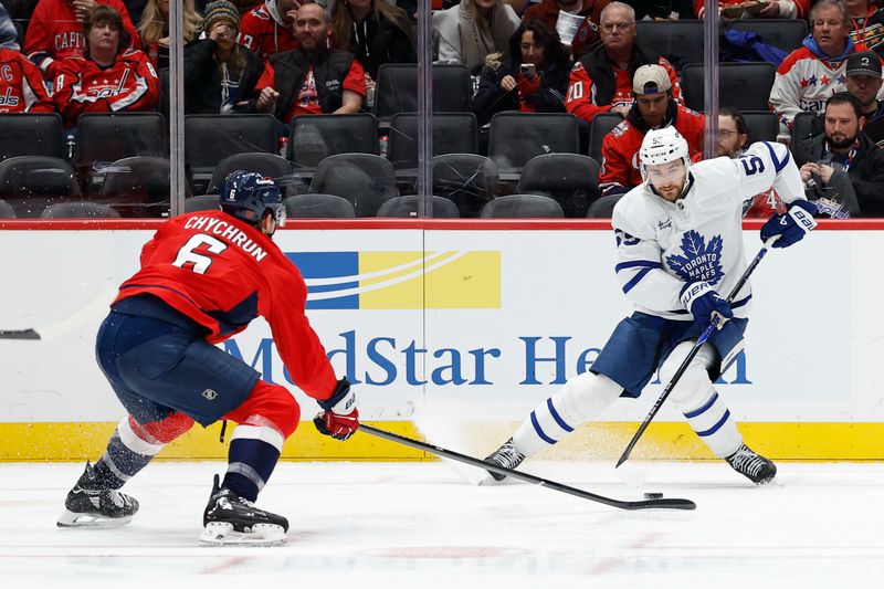 Dec 18, 2025; Washington, District of Columbia, USA; Toronto Maple Leafs center Nicolas Roy (55) skates with the puck as Washington Capitals defenseman Jakob Chychrun (6) defends during the second period at Capital One Arena. Mandatory Credit: Geoff Burke-Imagn Images