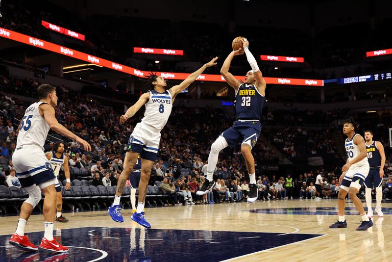 MINNEAPOLIS, MINNESOTA - OCTOBER 17: Aaron Gordon #32 of the Denver Nuggets shoots the ball against Josh Minott #8 of the Minnesota Timberwolves in the third quarter of a preseason game at Target Center on October 17, 2024 in Minneapolis, Minnesota. The Nuggets defeated the Timberwolves 132-126. NOTE TO USER: User expressly acknowledges and agrees that, by downloading and or using this photograph, User is consenting to the terms and conditions of the Getty Images License Agreement. (Photo by David Berding/Getty Images)