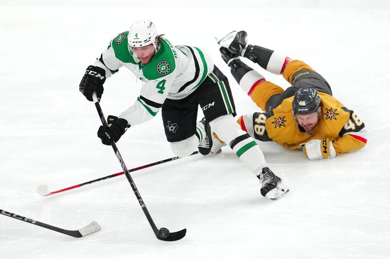 Dec 6, 2024; Las Vegas, Nevada, USA; Vegas Golden Knights center Tomas Hertl (48) falls behind Dallas Stars defenseman Miro Heiskanen (4) during the third period at T-Mobile Arena. Mandatory Credit: Stephen R. Sylvanie-Imagn Images