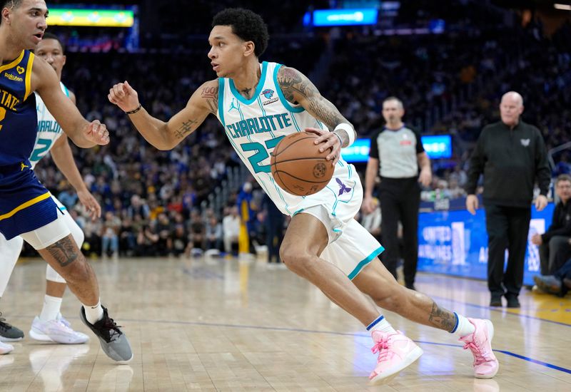 SAN FRANCISCO, CALIFORNIA - FEBRUARY 23: Tre Mann #23 of the Charlotte Hornets dribbling the ball looks to drive to the basket against the Golden State Warriors during the fourth quarter of an NBA basketball game at Chase Center on February 23, 2024 in San Francisco, California. NOTE TO USER: User expressly acknowledges and agrees that, by downloading and or using this photograph, User is consenting to the terms and conditions of the Getty Images License Agreement. (Photo by Thearon W. Henderson/Getty Images)