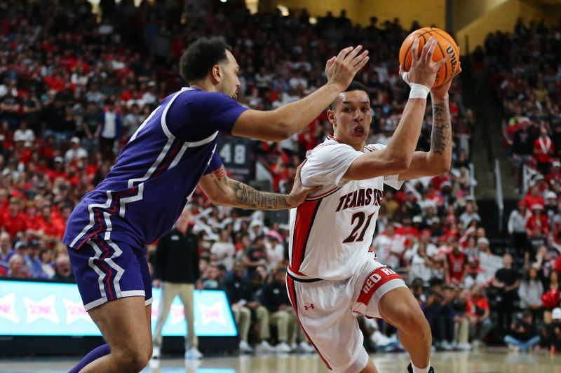 Feb 20, 2024; Lubbock, Texas, USA;  Texas Tech Red Raiders forward KyeRon Lindsay (21) drives the ball against TCU Horned Frogs forward JaKobe Coles (21) in the second half at United Supermarkets Arena. Mandatory Credit: Michael C. Johnson-USA TODAY Sports