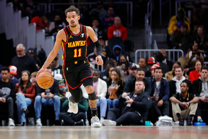 ATLANTA, GEORGIA - JANUARY 20: Trae Young #11 of the Atlanta Hawks drives down court against the Cleveland Cavaliers during the second half at State Farm Arena on January 20, 2024 in Atlanta, Georgia. NOTE TO USER: User expressly acknowledges and agrees that, by downloading and or using this photograph, User is consenting to the terms and conditions of the Getty Images License Agreement. (Photo by Alex Slitz/Getty Images)