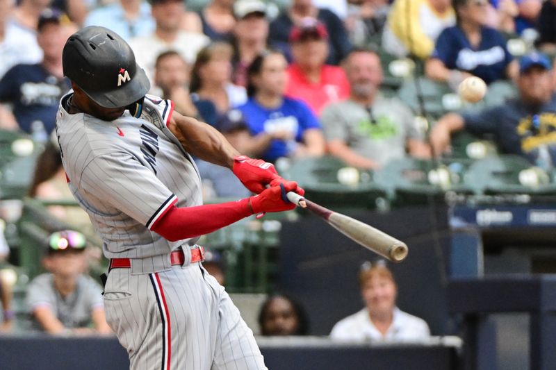 Aug 23, 2023; Milwaukee, Wisconsin, USA; Minnesota Twins center fielder Michael Taylor (2) hits a two run home run in the fourth inning against the Milwaukee Brewers at American Family Field. Mandatory Credit: Benny Sieu-USA TODAY Sports