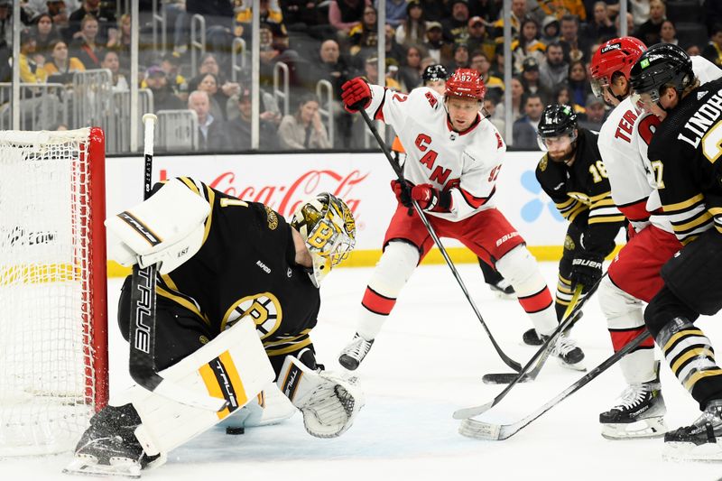 Apr 9, 2024; Boston, Massachusetts, USA; Carolina Hurricanes left wing Teuvo Teravainen (86) slides the puck between the pads of Boston Bruins goaltender Jeremy Swayman (1) during the second period at TD Garden. Mandatory Credit: Bob DeChiara-USA TODAY Sports