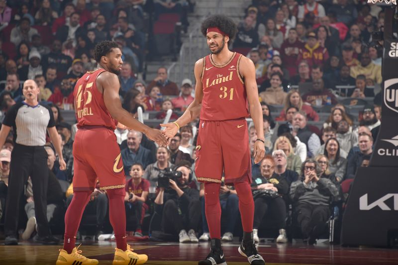 CLEVELAND, OH - FEBRUARY 12: Jarrett Allen #31 of the Cleveland Cavaliers high fives Donovan Mitchell #45 during the game against the Philadelphia 76ers on February 12, 2024 at Rocket Mortgage FieldHouse in Cleveland, Ohio. NOTE TO USER: User expressly acknowledges and agrees that, by downloading and/or using this Photograph, user is consenting to the terms and conditions of the Getty Images License Agreement. Mandatory Copyright Notice: Copyright 2024 NBAE (Photo by David Liam Kyle/NBAE via Getty Images)