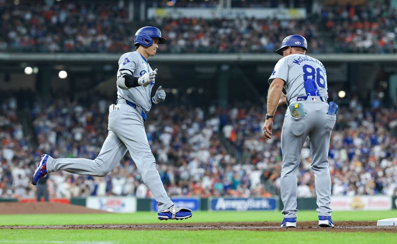 Jul 27, 2024; Houston, Texas, USA; Los Angeles Dodgers designated hitter Shohei Ohtani (17) celebrates with first base coach Clayton McCullough (86) after hitting a home run during the third inning against the Houston Astros at Minute Maid Park. Mandatory Credit: Troy Taormina-USA TODAY Sports