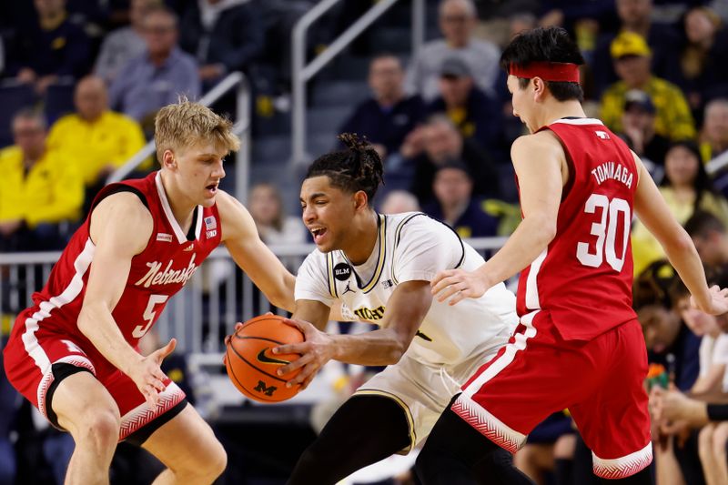 Feb 8, 2023; Ann Arbor, Michigan, USA;  Michigan Wolverines guard Jett Howard (13) is defended by Nebraska Cornhuskers guard Sam Griesel (5) and guard Keisei Tominaga (30) in the second half at Crisler Center. Mandatory Credit: Rick Osentoski-USA TODAY Sports